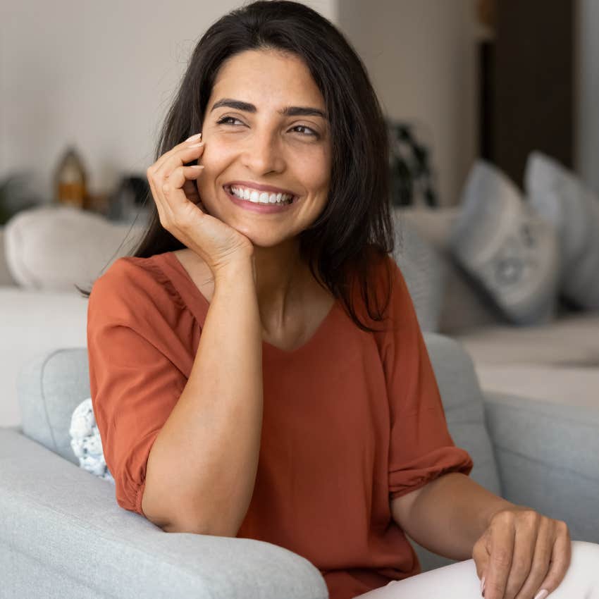 Patient woman who grew up in the 1980s sitting alone at home