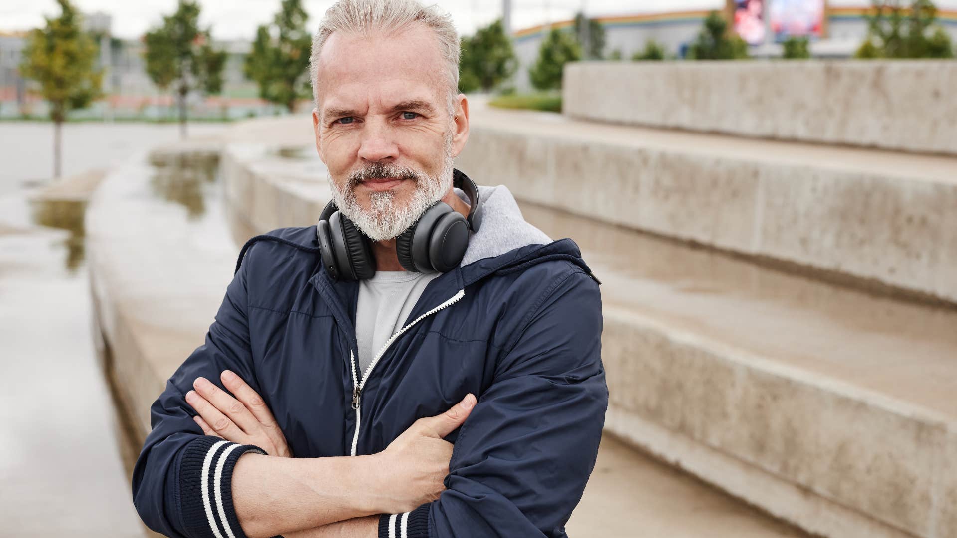 Man who's quietly independent standing outside.