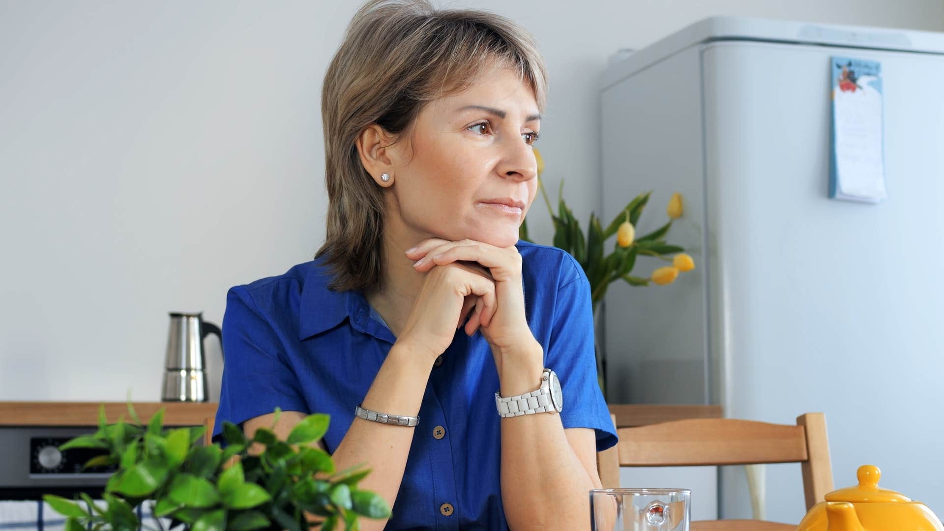 Woman who's secure in herself sitting at home.