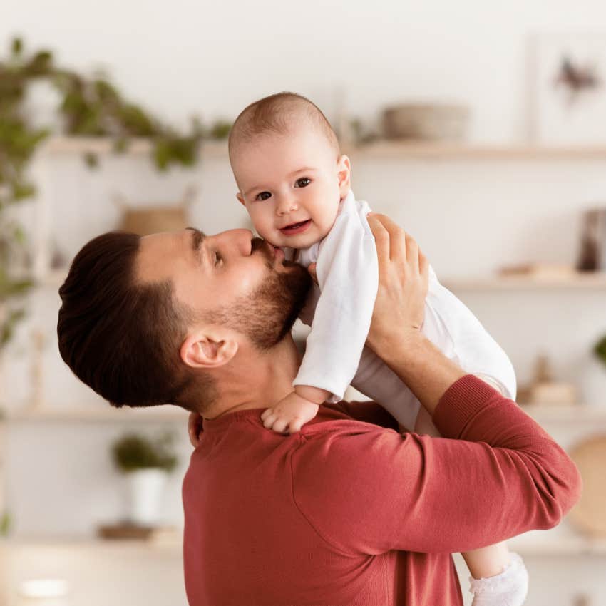 dad holding baby showing warmth and affection