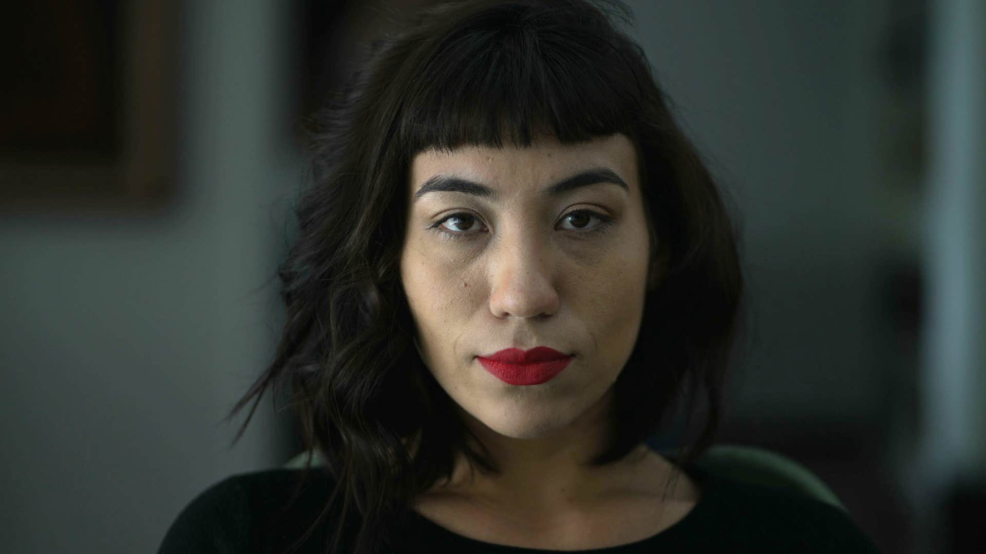 Serious woman stares blankly showing anger stage