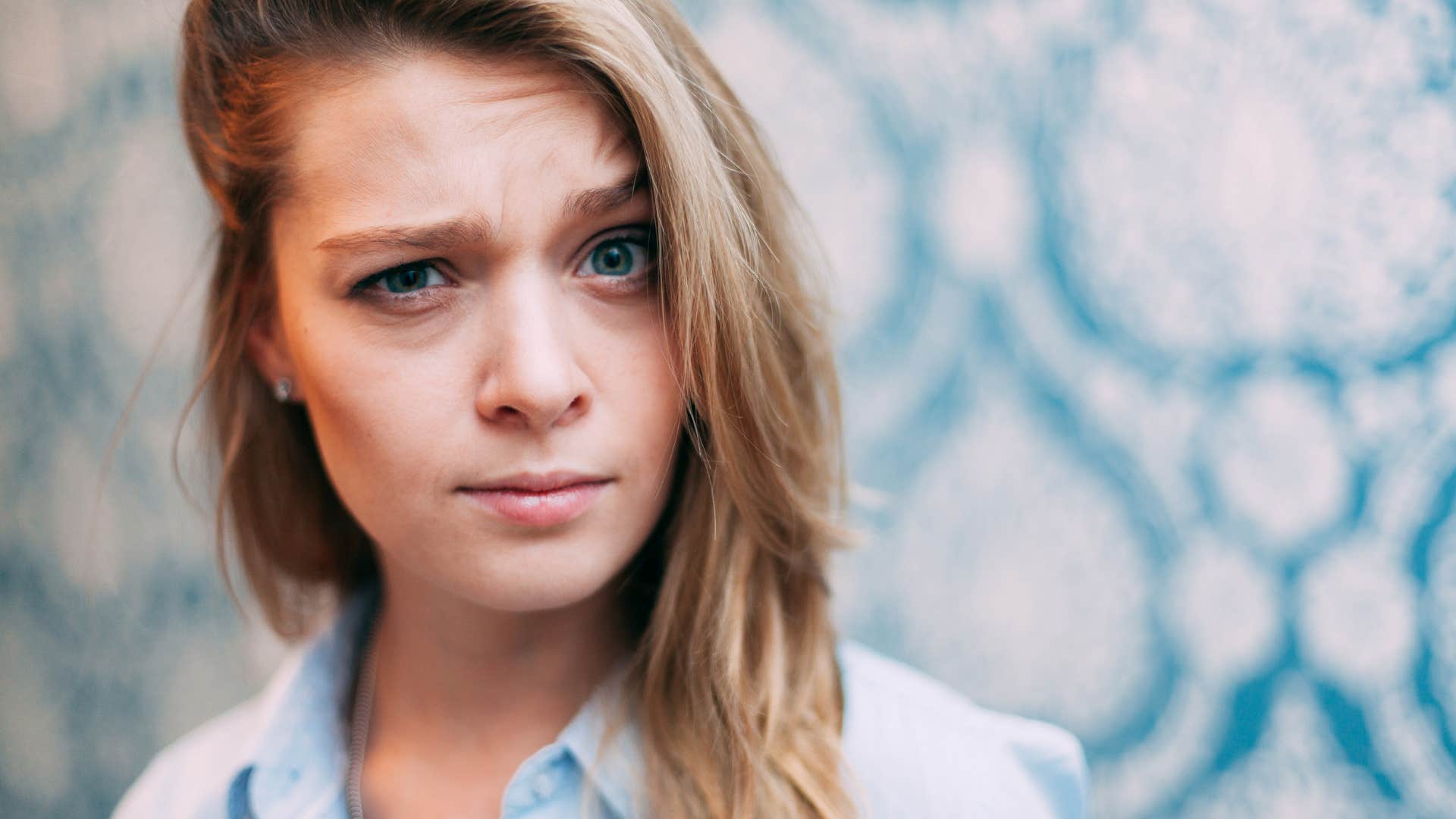 uncertain woman raises eyebrow showing doubt stage