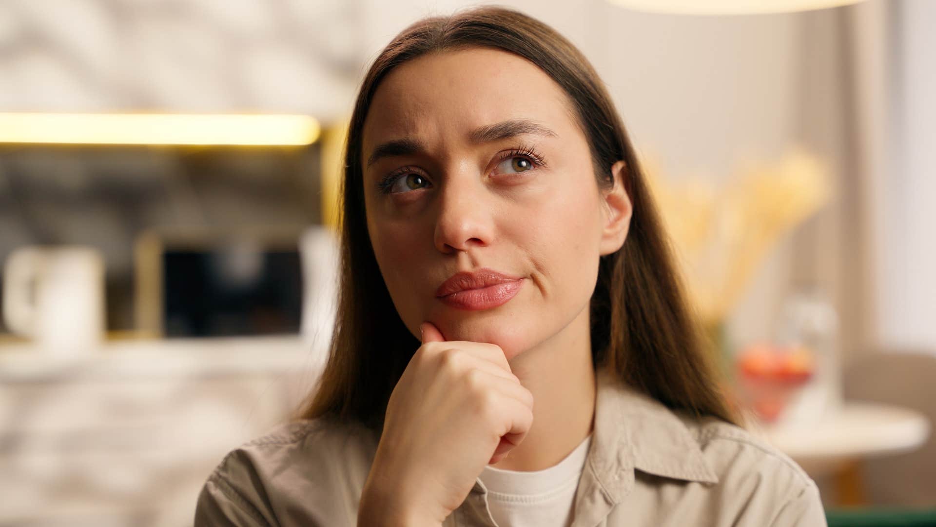 Deep thinking woman with hand on chin showing obsession stage