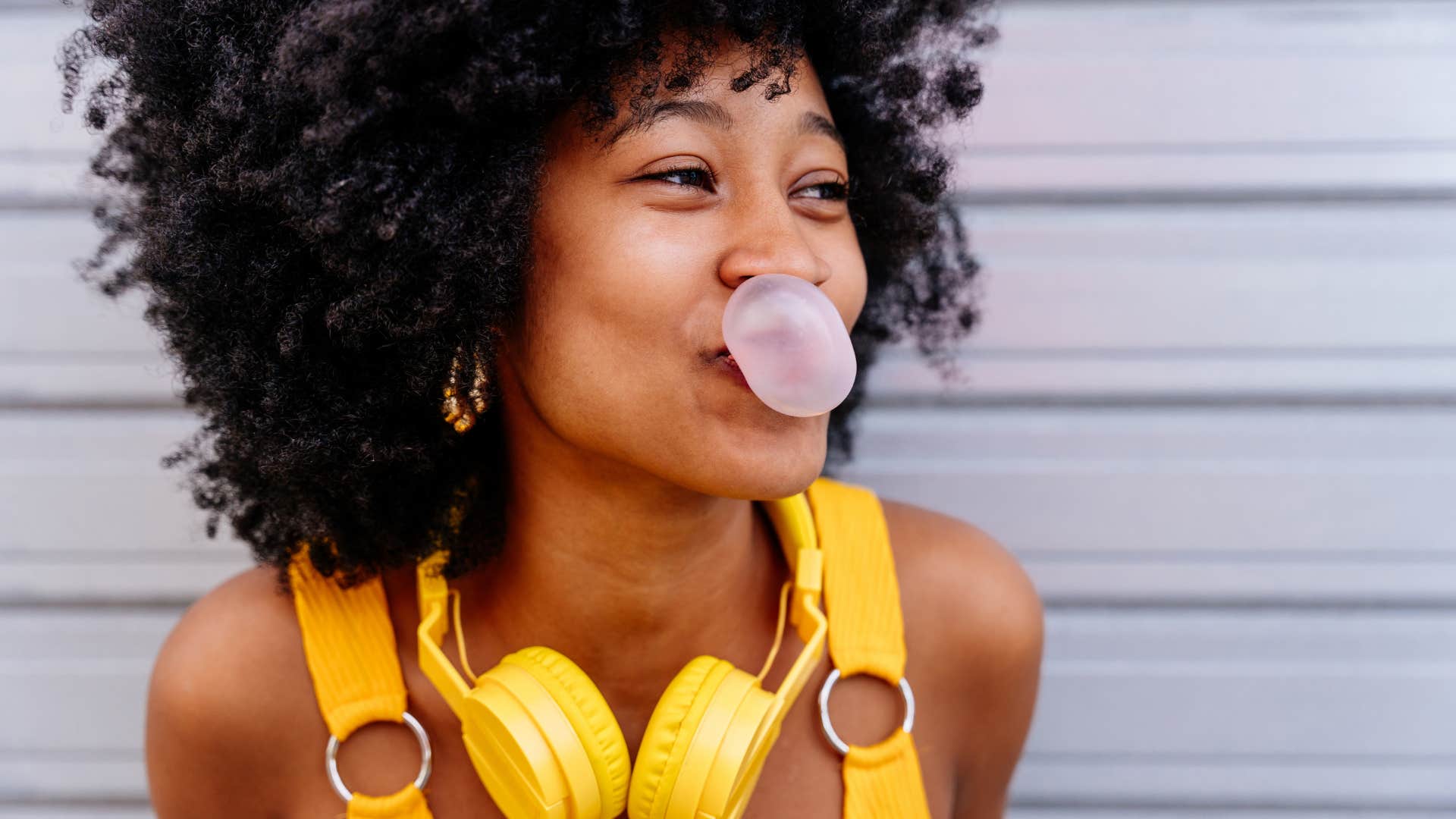 Happy woman blows bubble with gum showing relief stage