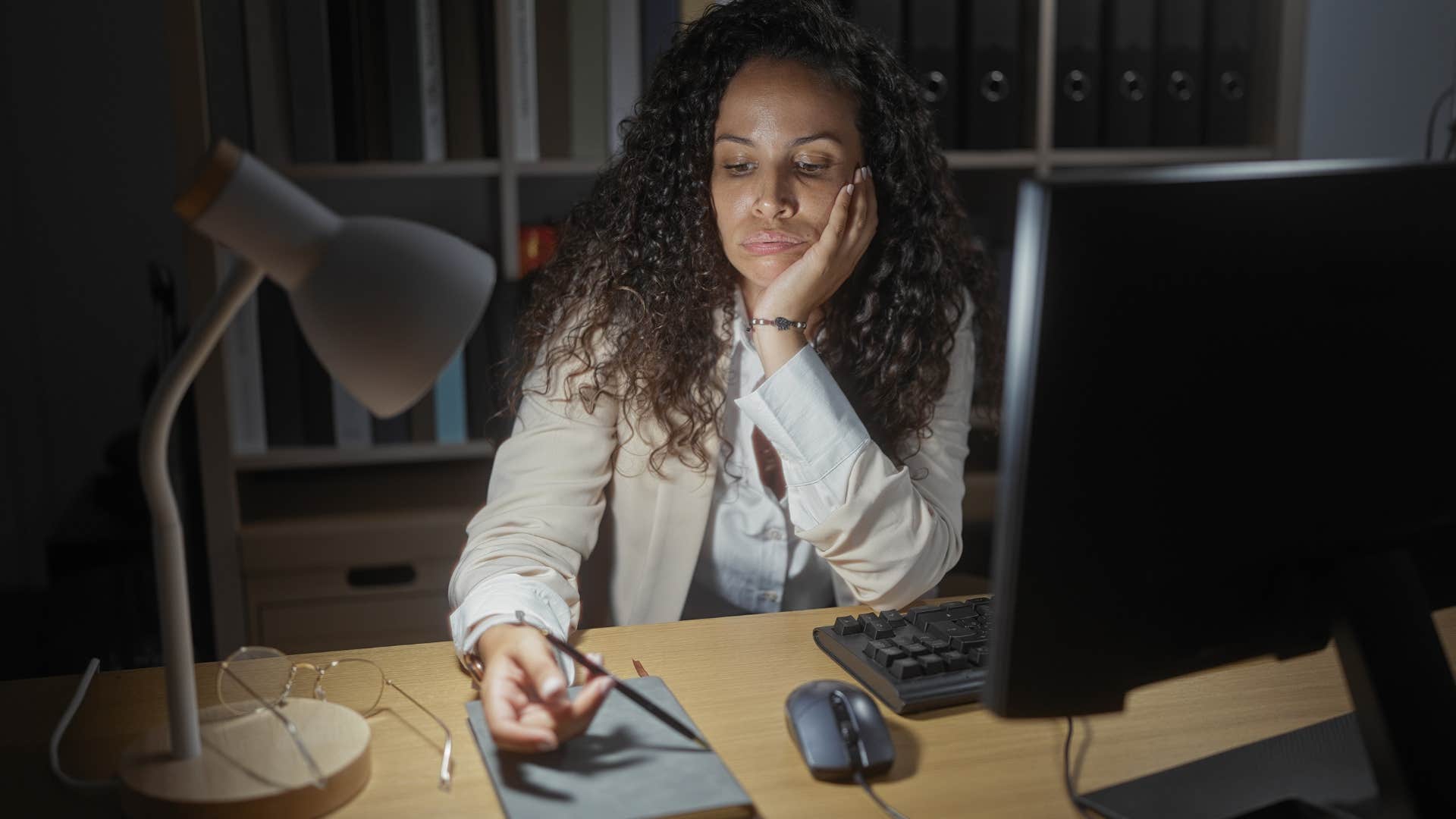 Upset woman fidgets with pen showing shame stage