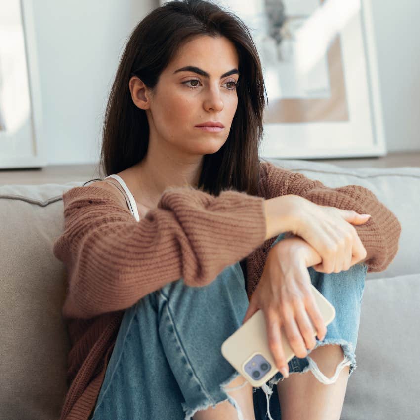 Woman who is lonelier than her parents realize with podcast playing in the background on her phone