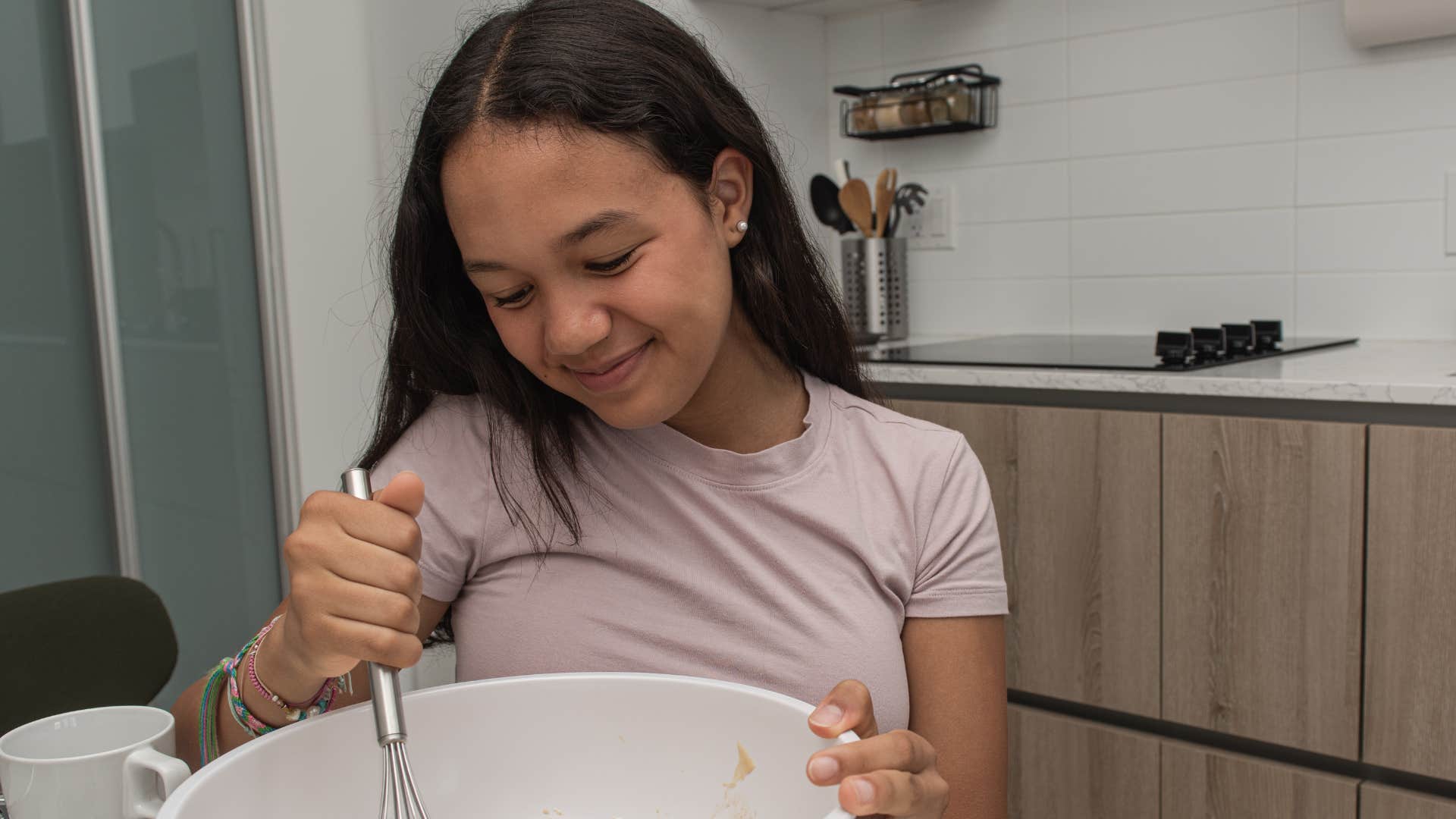 Little girl cooking for themselves at home alone.
