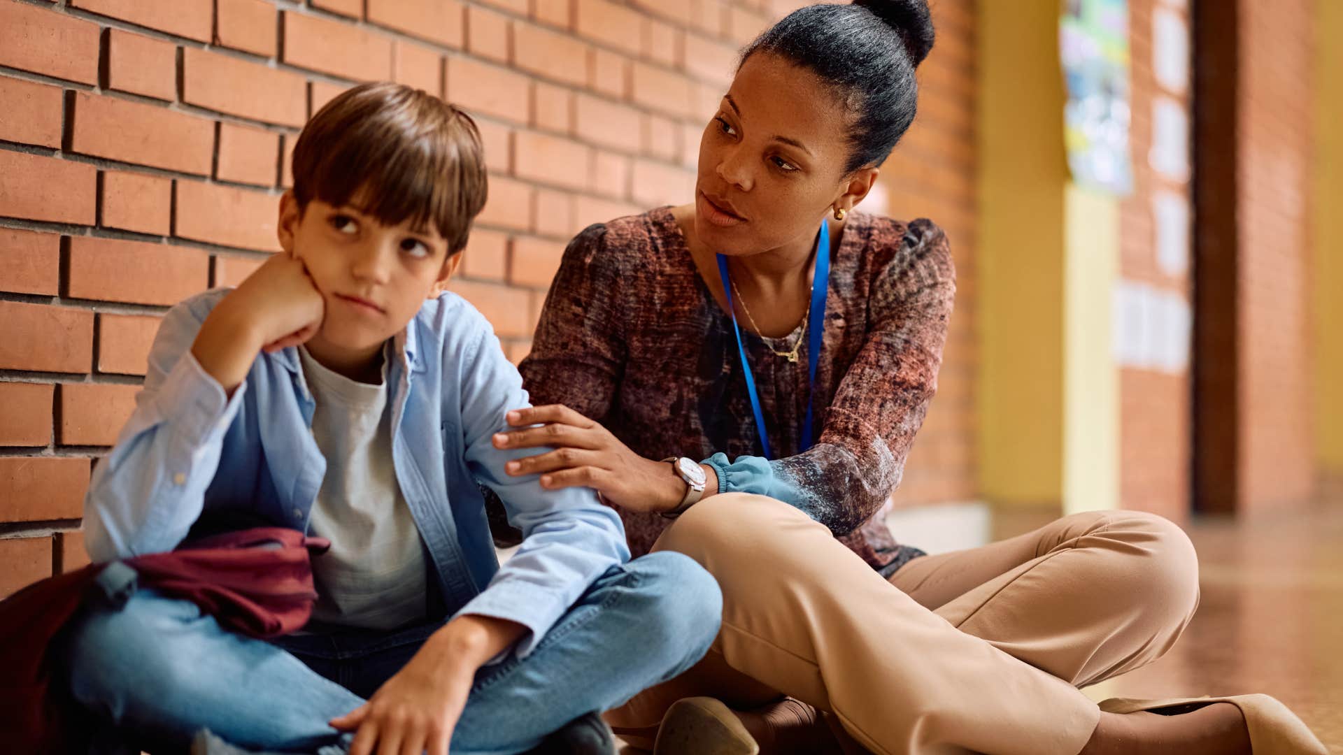 Little boy talking to a stranger at school