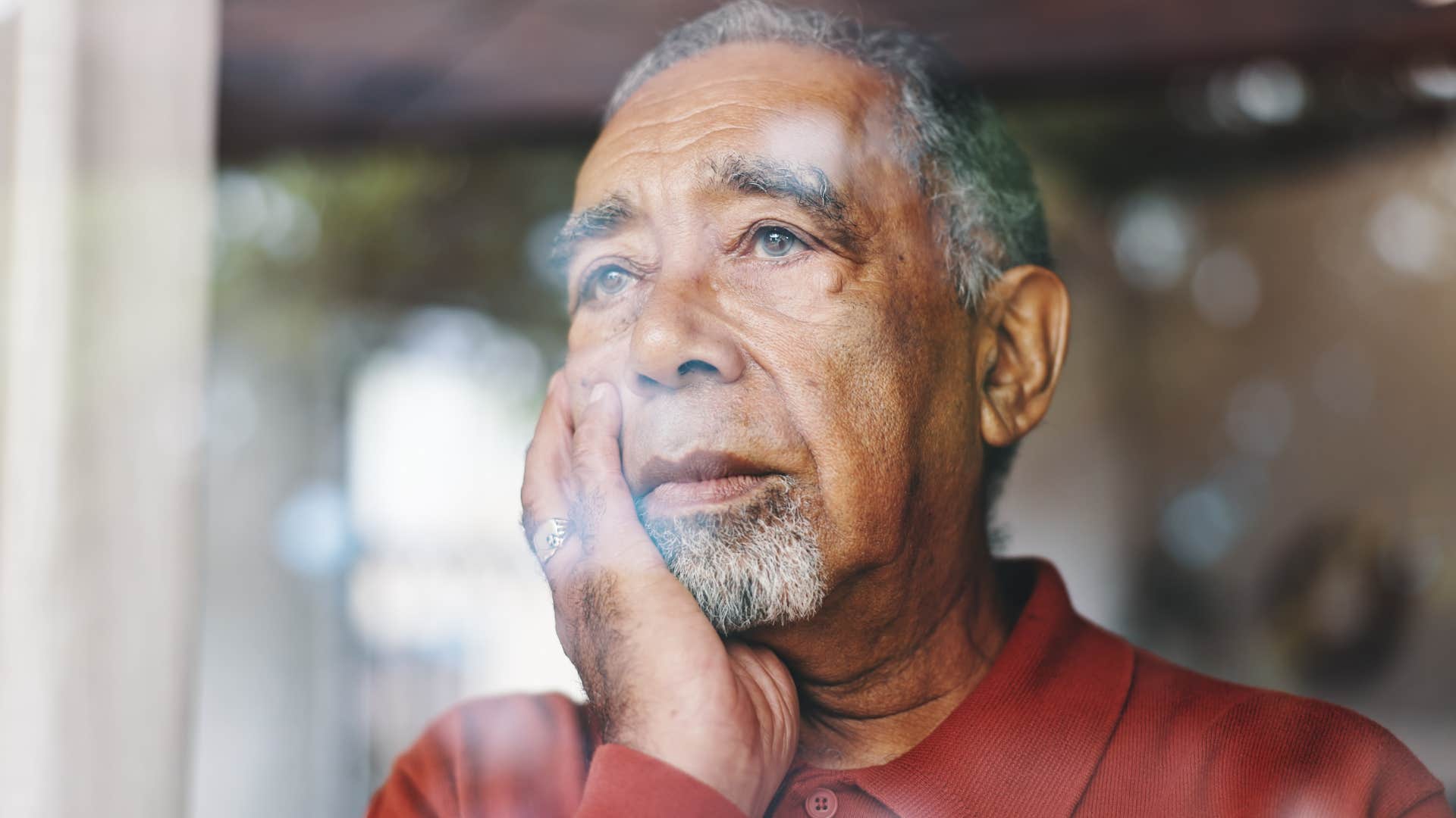 man looking at windows fogging up at host's home