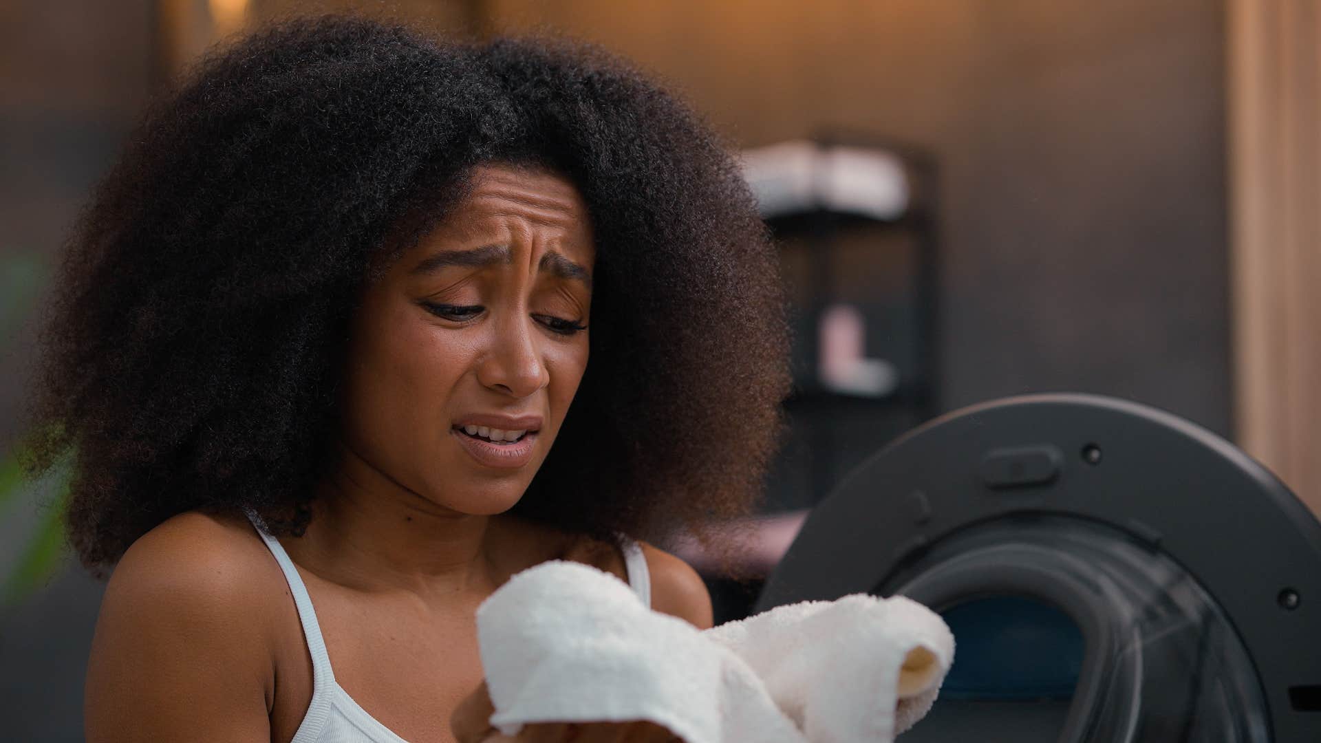 woman grossed out smelling musty towels