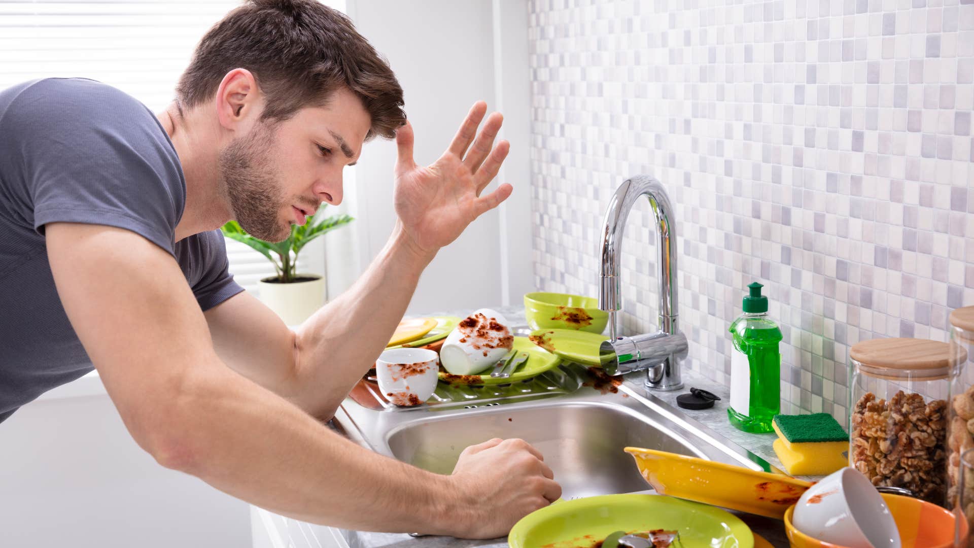 man looking at food in the sink grain feeling grossed out