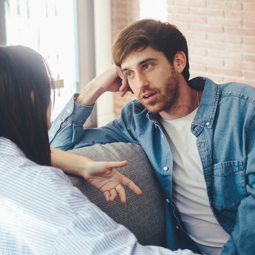 man analyzing the sides of a woman's face while talking to her
