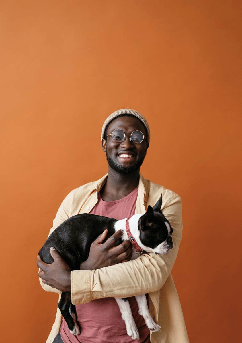 level-headed young man holding his dog