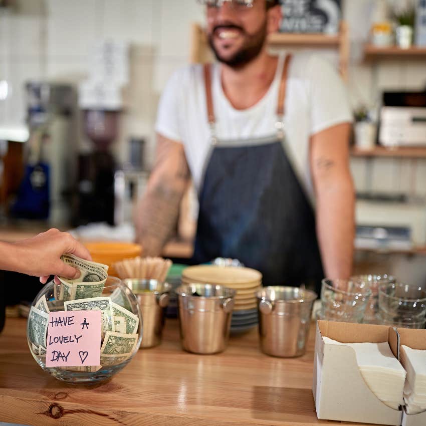 person tipping a barista