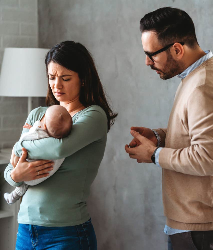 upset couple with baby disagree showing new parents
