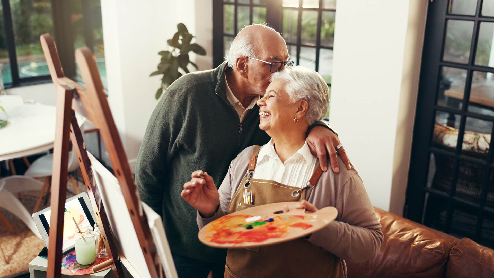 Happy woman paints for supportive husband showing he is invested