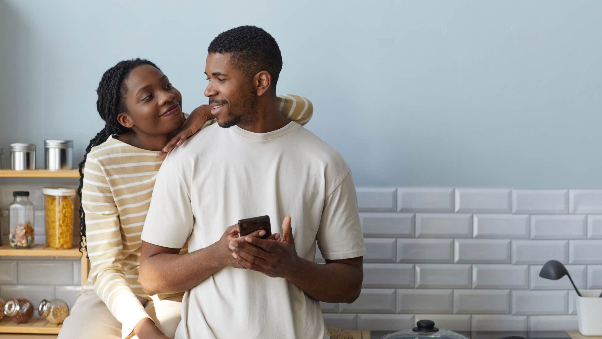 couple talking in the kitchen man including partner in his decisions