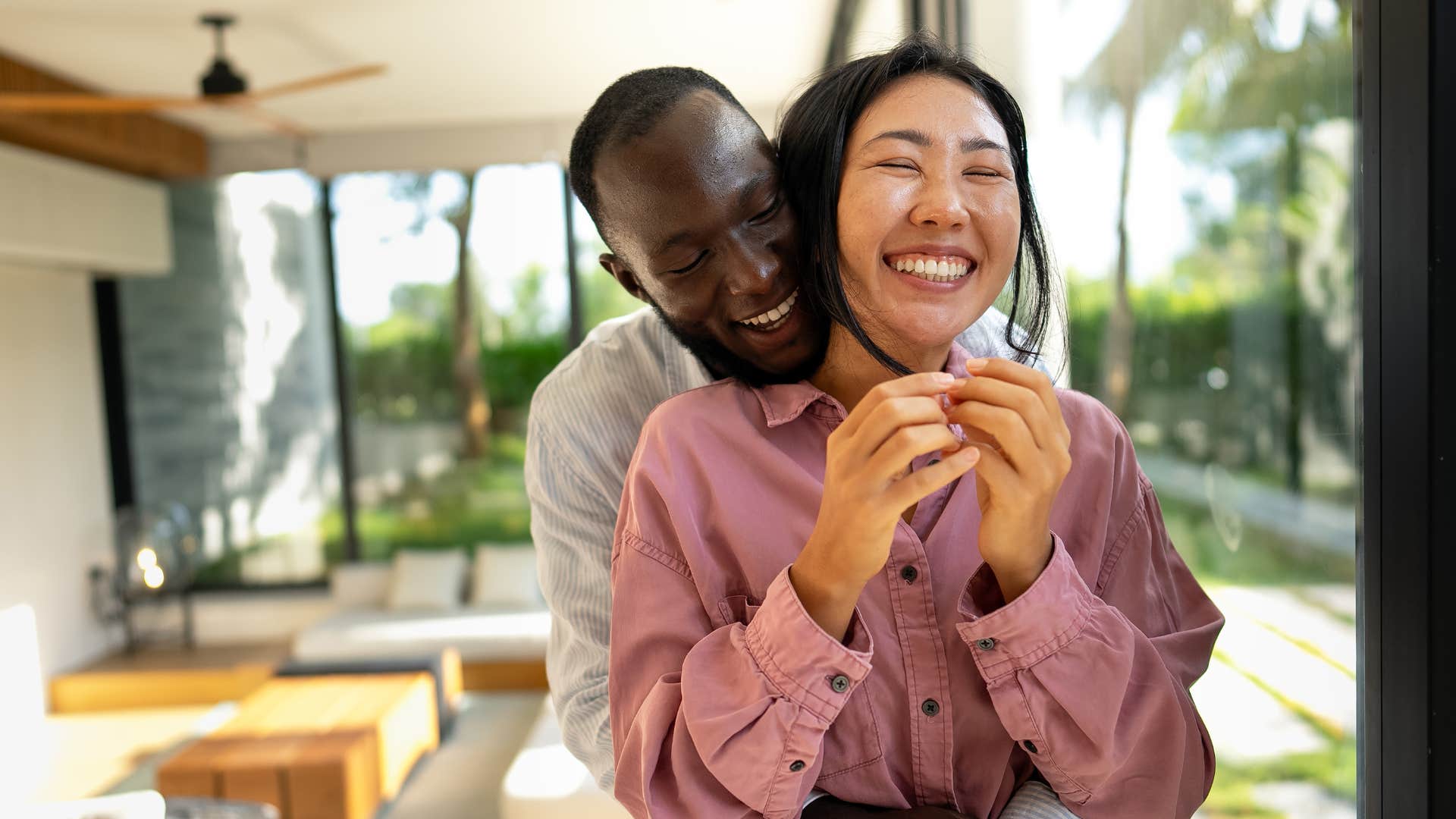 man playfully teasing his partner laughing together