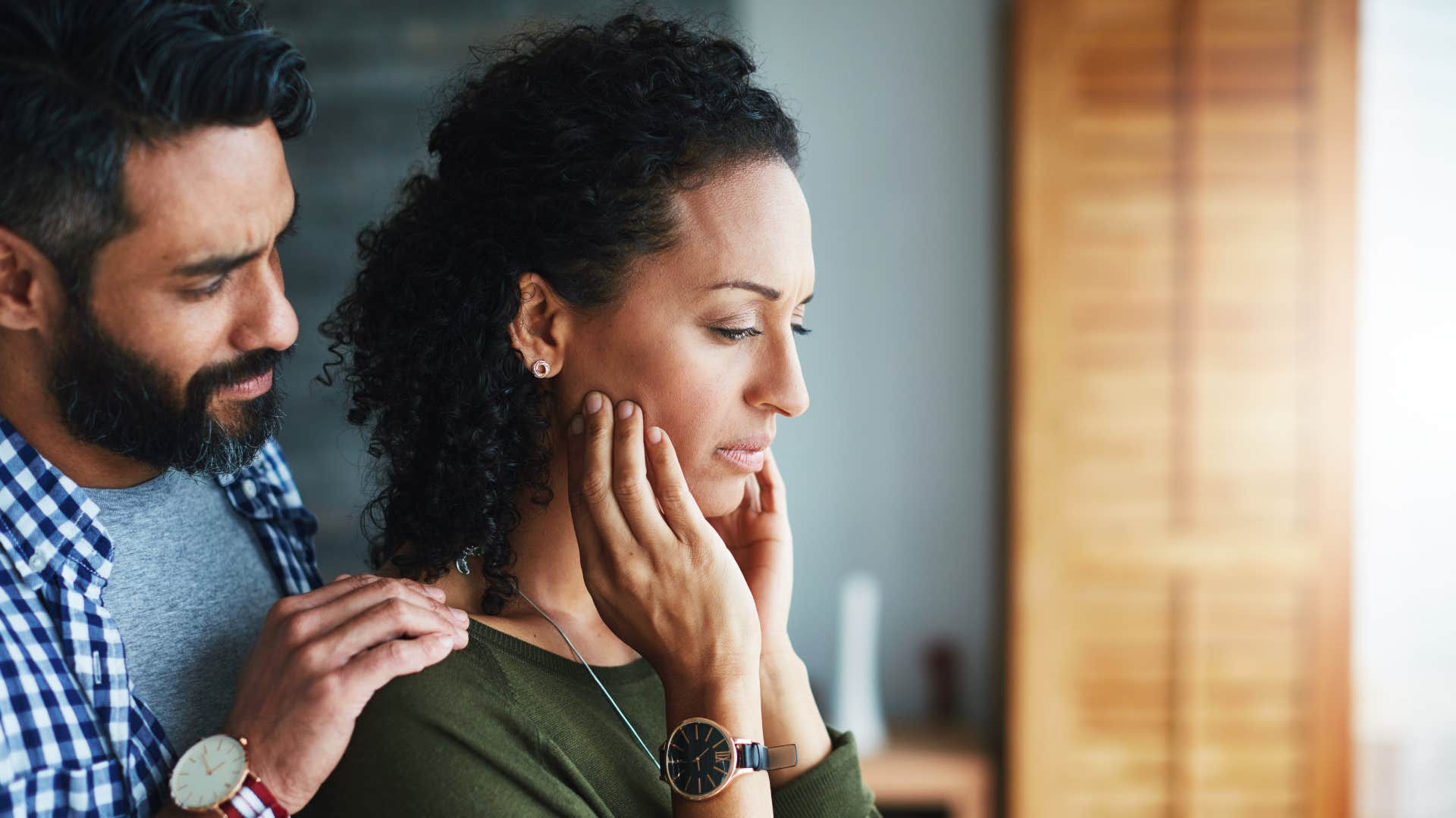 man reassuring his upset partner