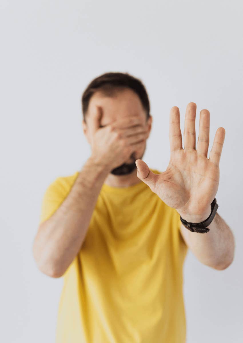 man holding up his hand 