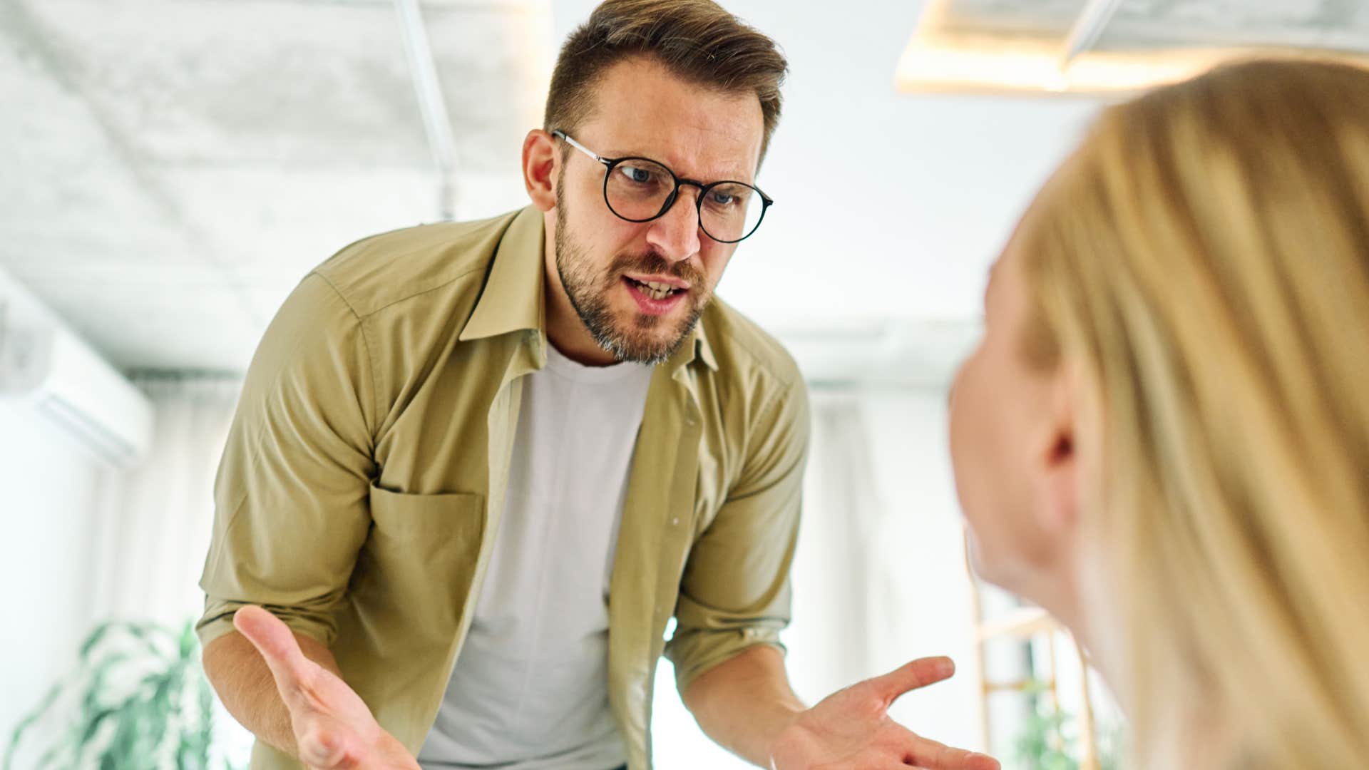 resentful man yelling at his wife