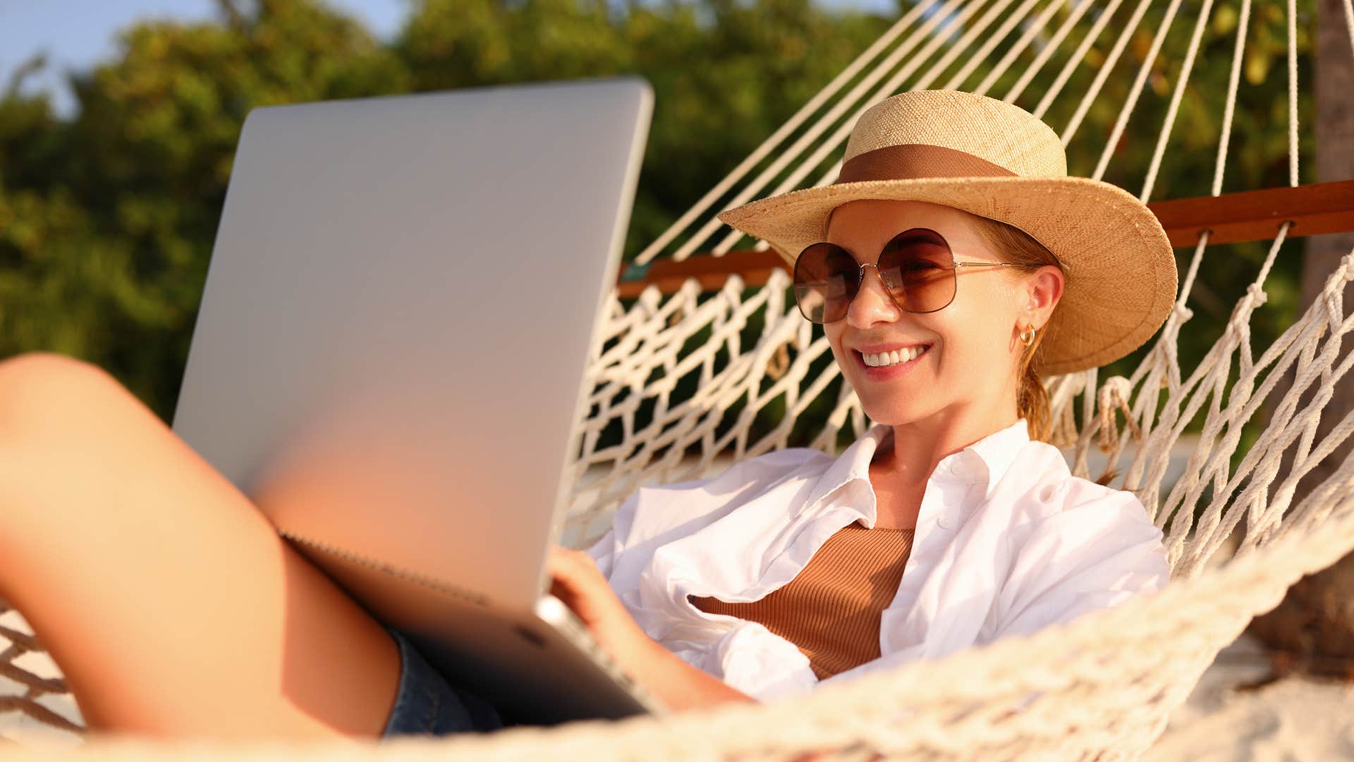 Happy woman relaxes and works showing good life after marrying wrong man