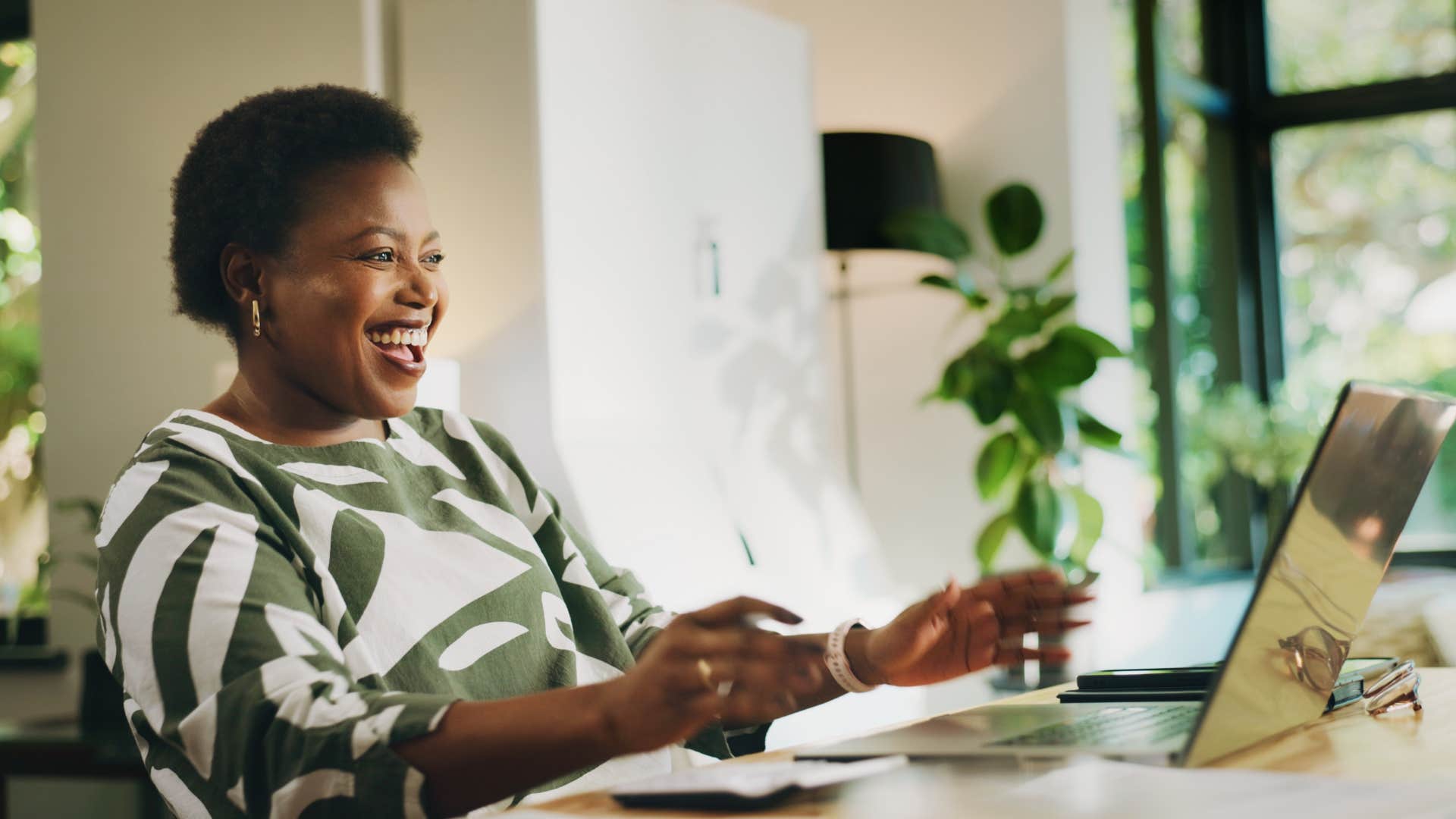Happy person with computer showing success after marrying wrong man