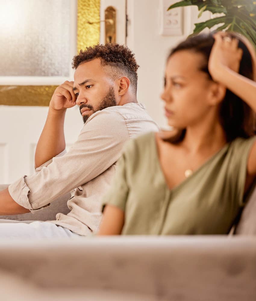 Upset couple face away from each other showing fear of commitment