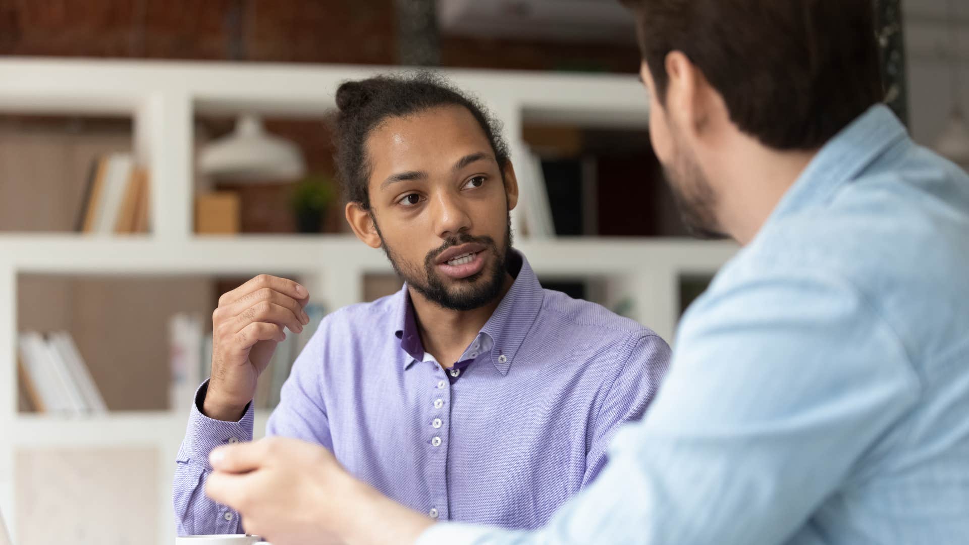 man talking with colleague not feeling anxious about judgment