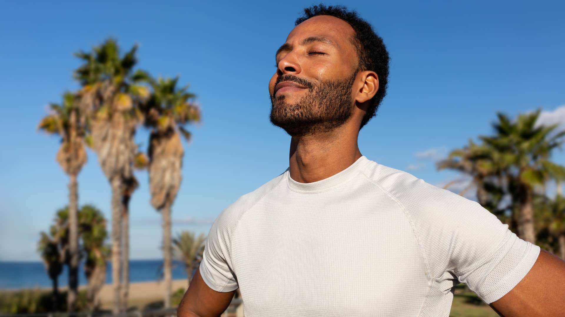 quietly confident man standing in the sun outside