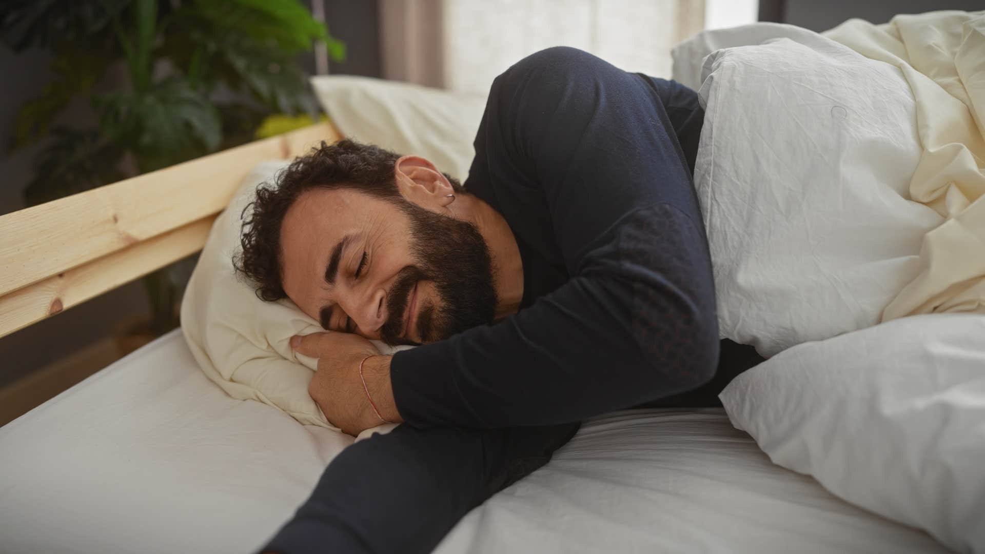 relaxed man sleeping in bed