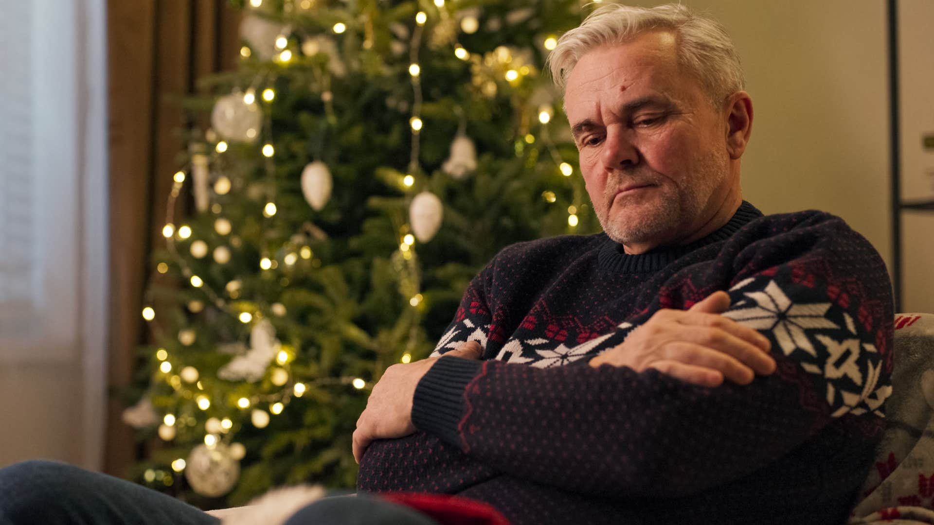 stressed sad man isolating himself at home during the holidays