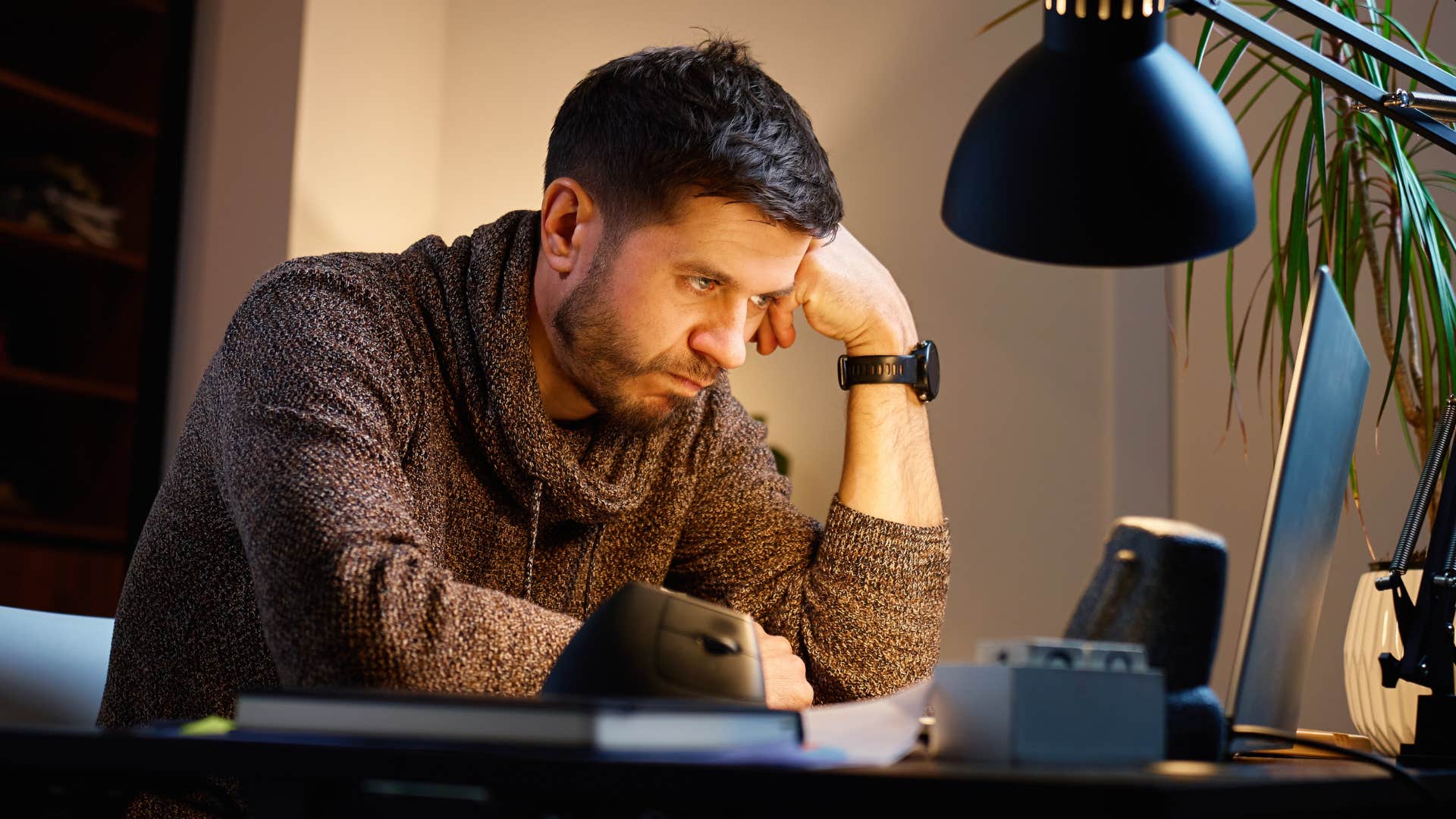 stressed man hiding behind silence with workaholic tendencies
