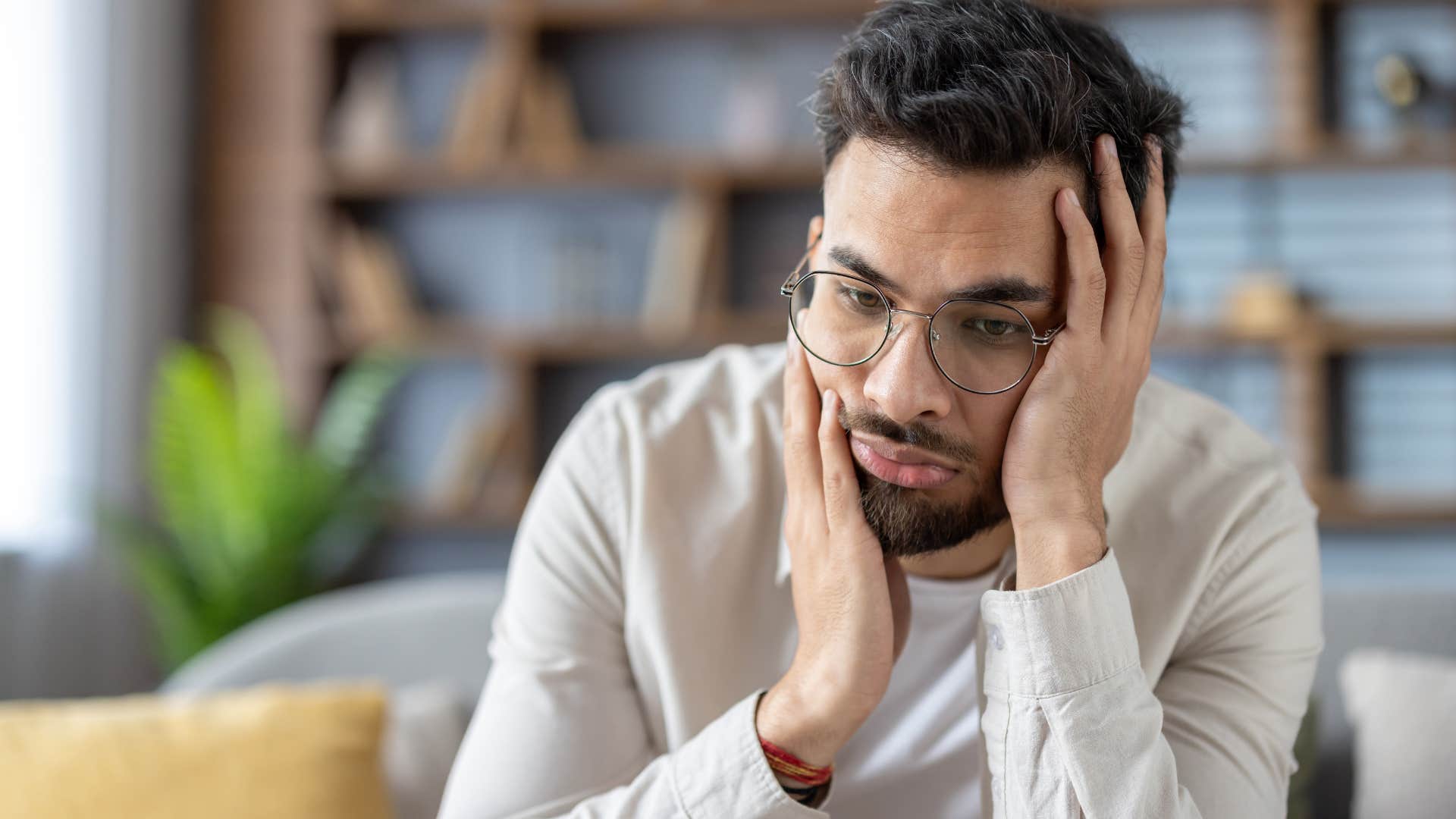 stressed man sitting at home zoning out
