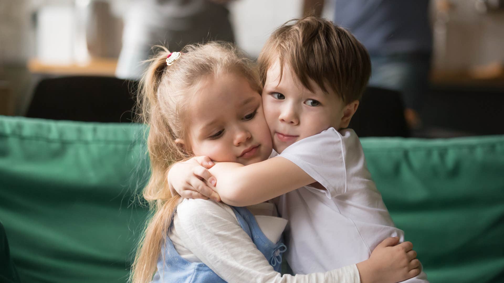 young boy hugging his sister being responsible for her