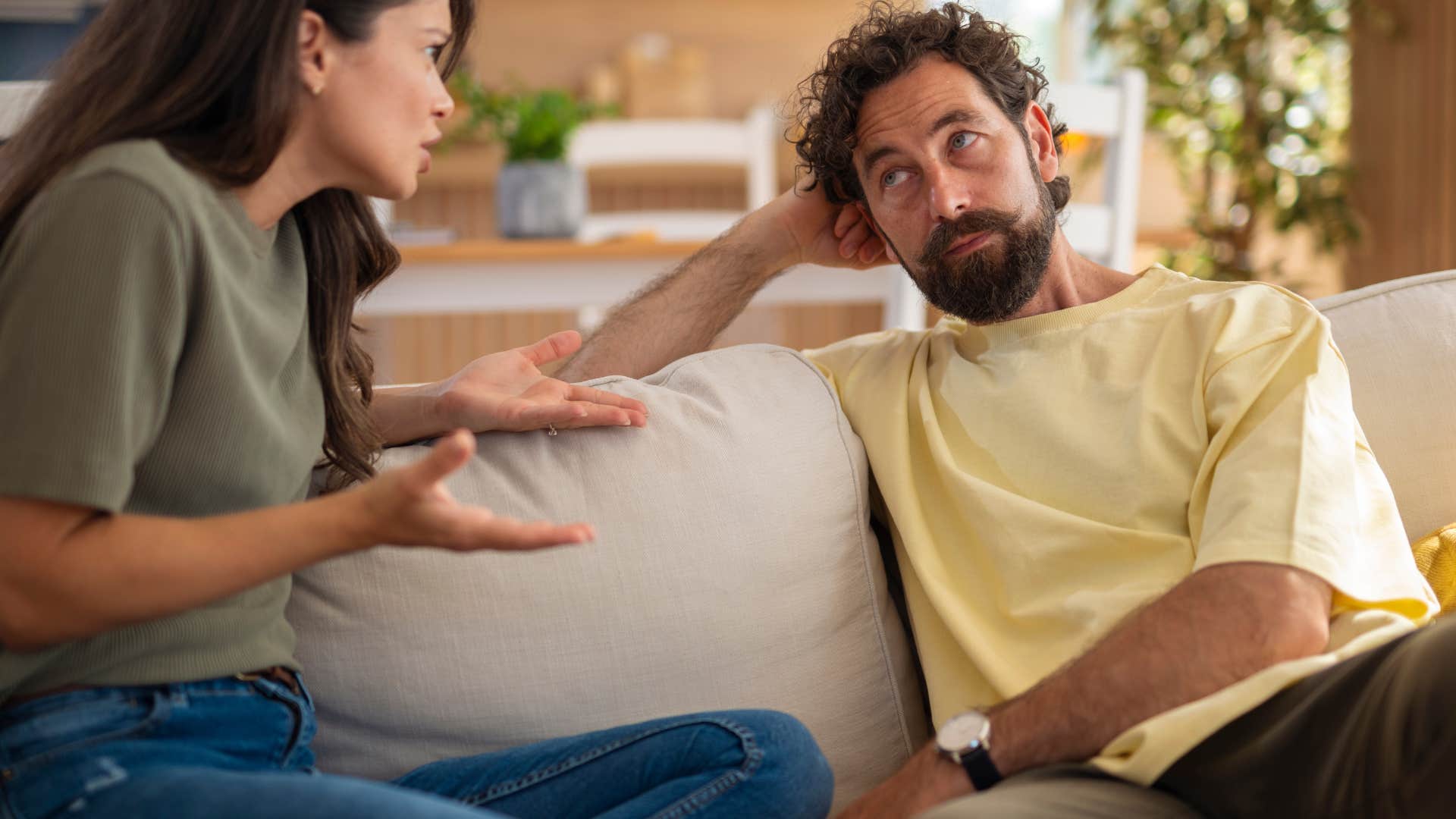 Man who's bored by long-term planning sitting with his partner.