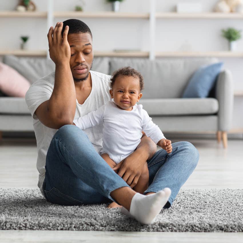 dad who is sleep deprived struggling to take care of baby