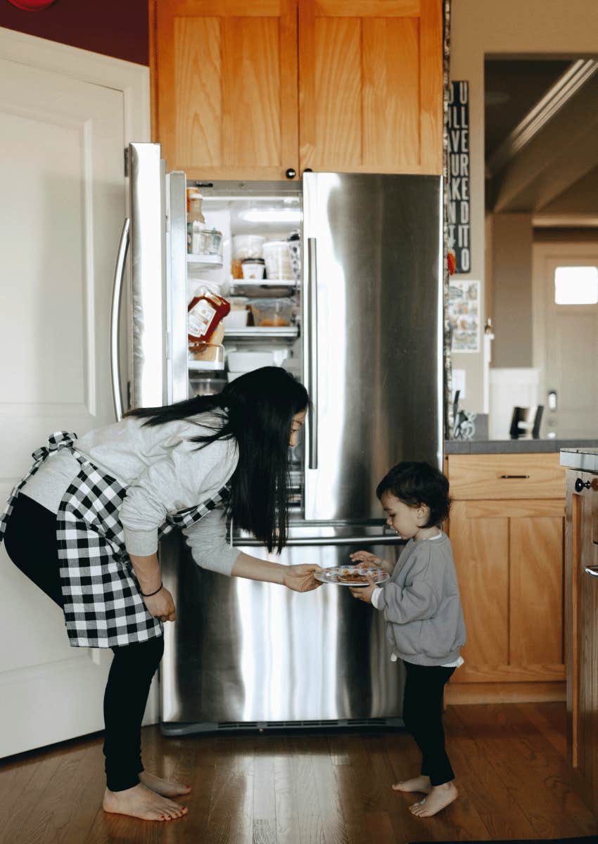 mom giving child a snack