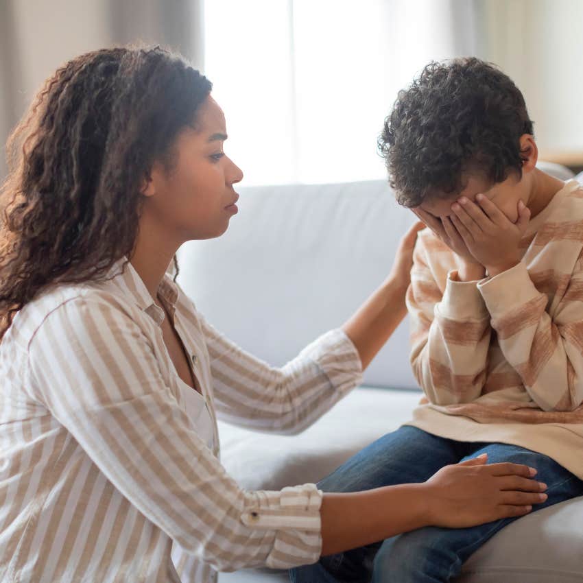 mom comforting her crying son after punishing him