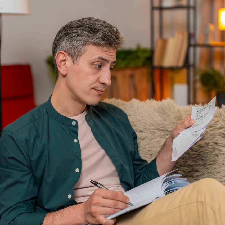 man who got a peanut butter raise looking at pay stub