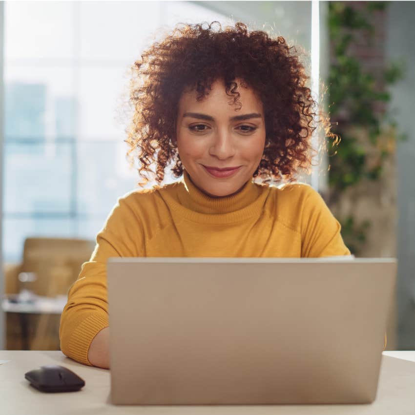 woman working at her computer managing intent and impact
