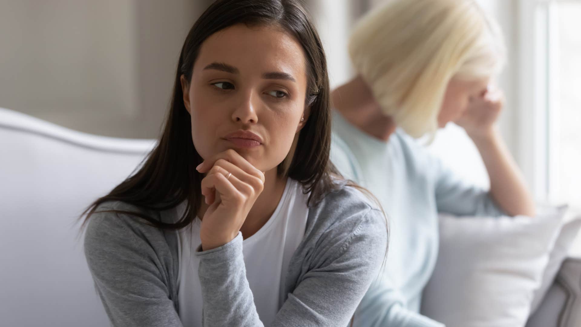 upset woman turned away from narcissistic mom who said after everything i've done for you