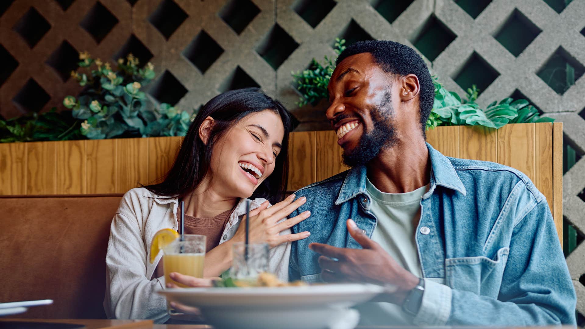 Affectionate couple laugh over shared meal showing way to be captivating