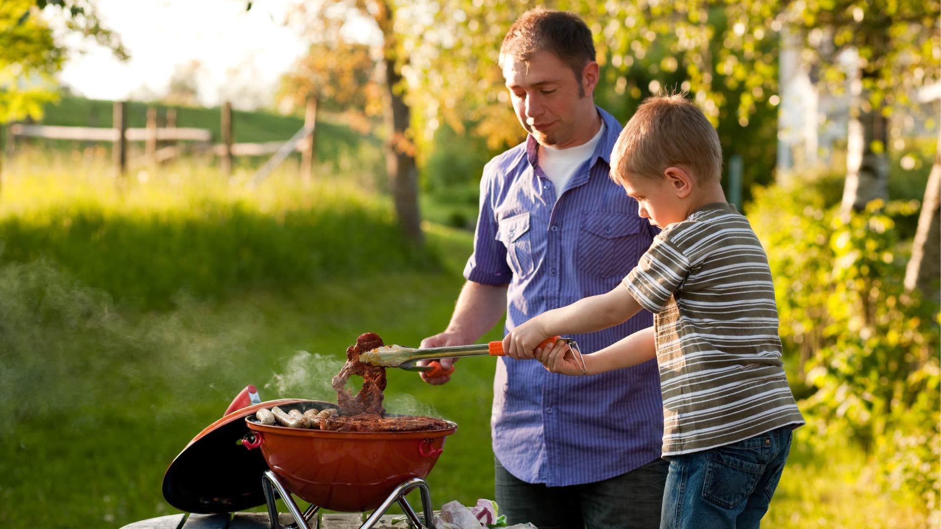 Kind man and kid barbecue showing way to be captivating