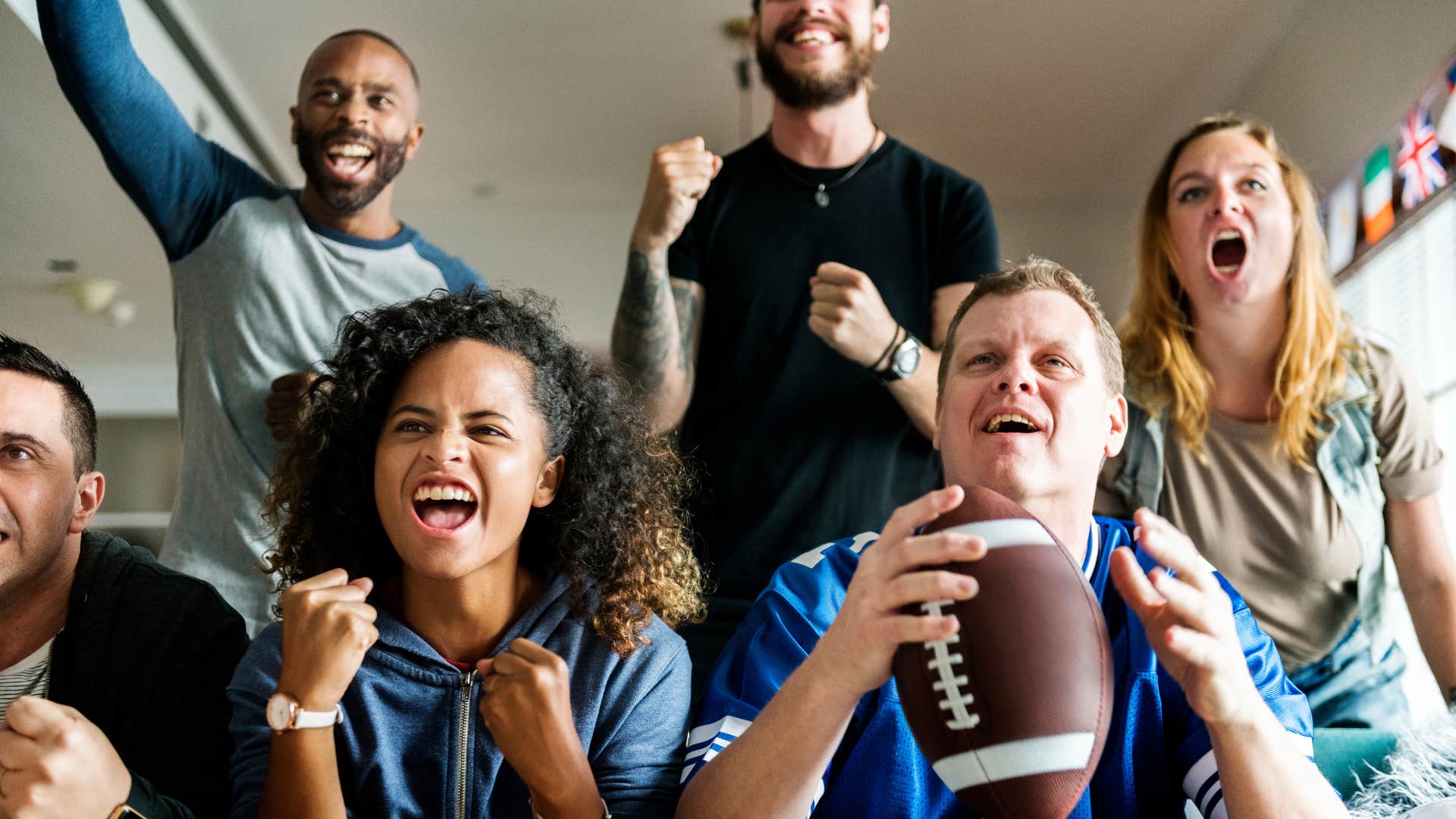 Excited sports fans wathc game showing happy couples keep hobbies