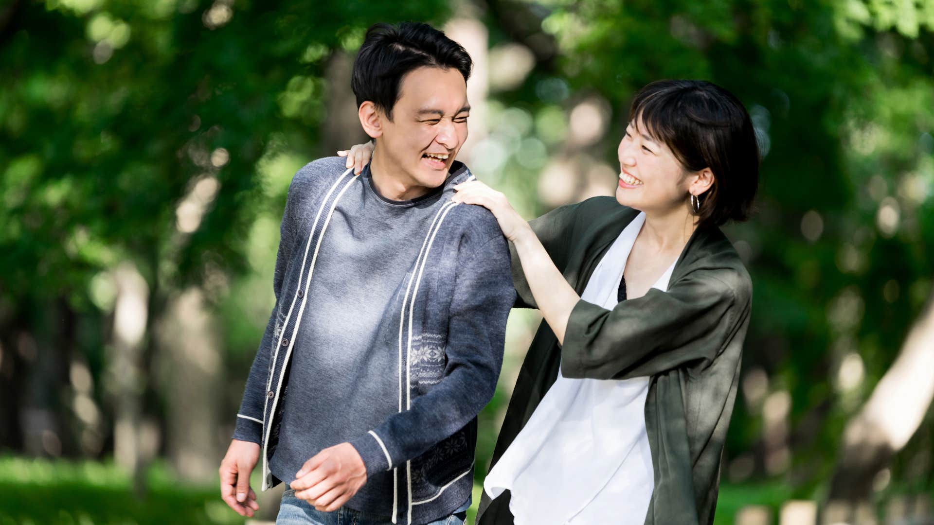 Married couple touch each other on walk