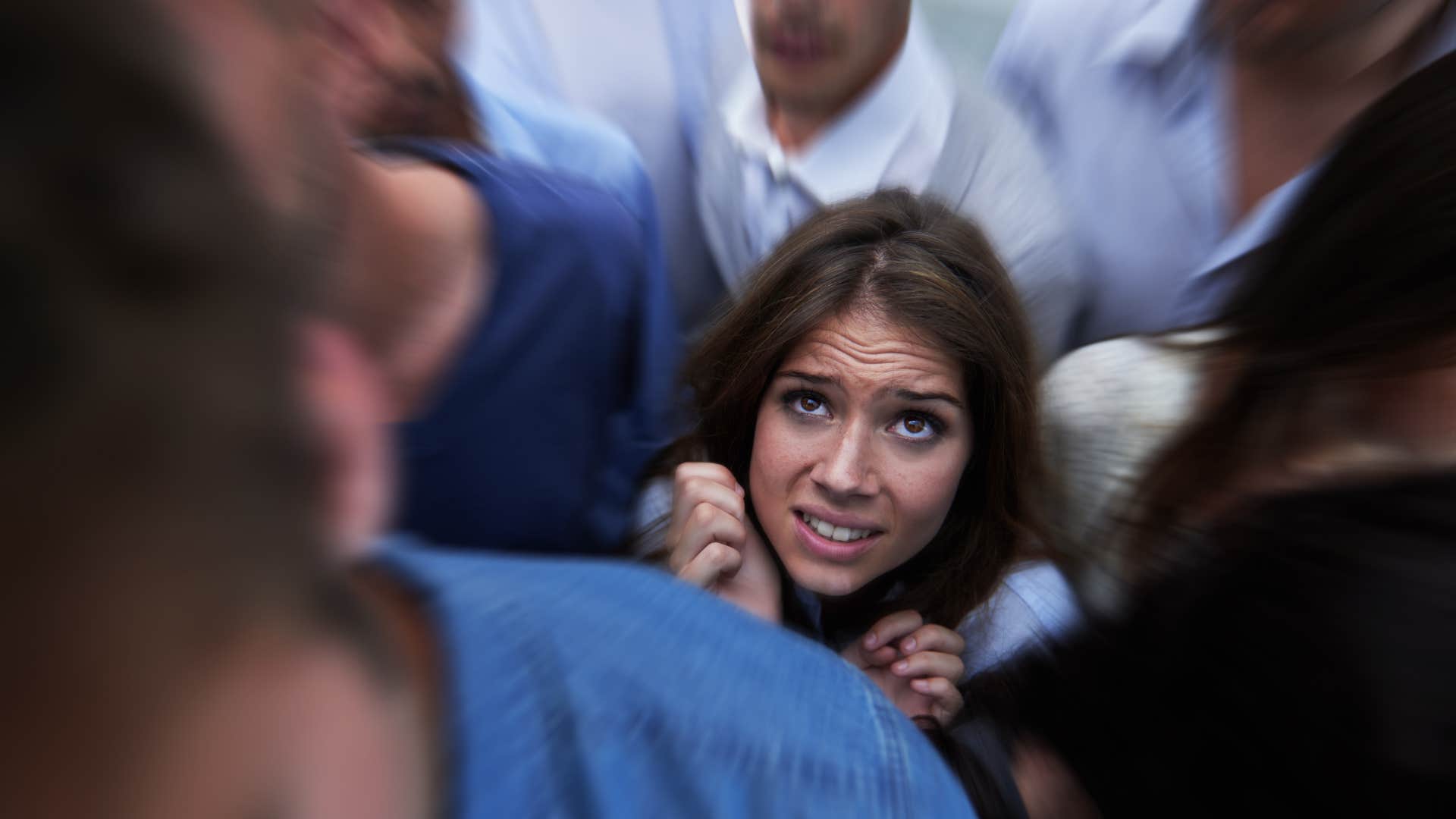 Fearful person stuck in crowd showing they might be obsessed