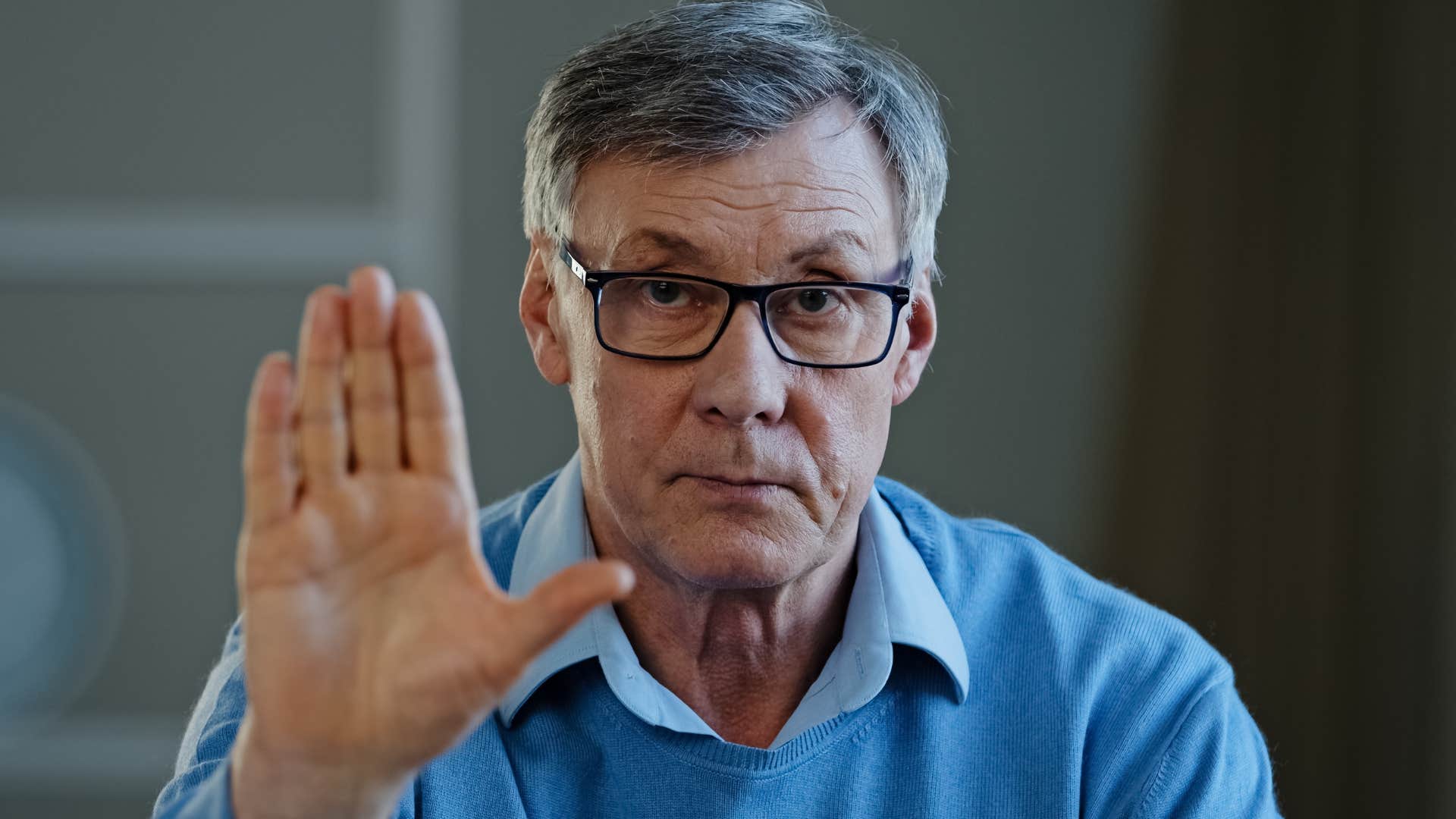 Opinionated person puts up hand to stop showing they might be obsessed with being right