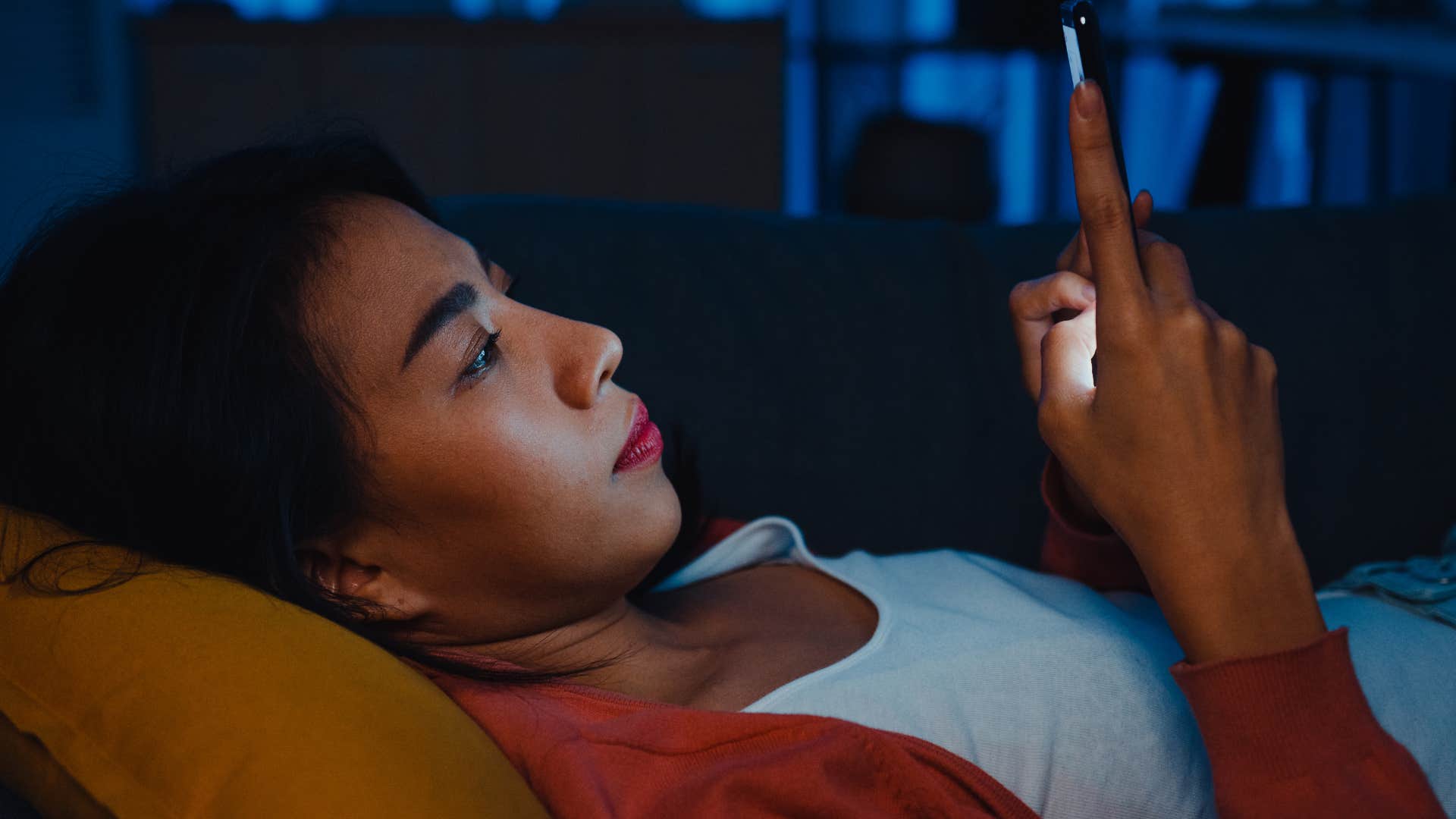 Tired person scrolls on phone showing they might be obsessed