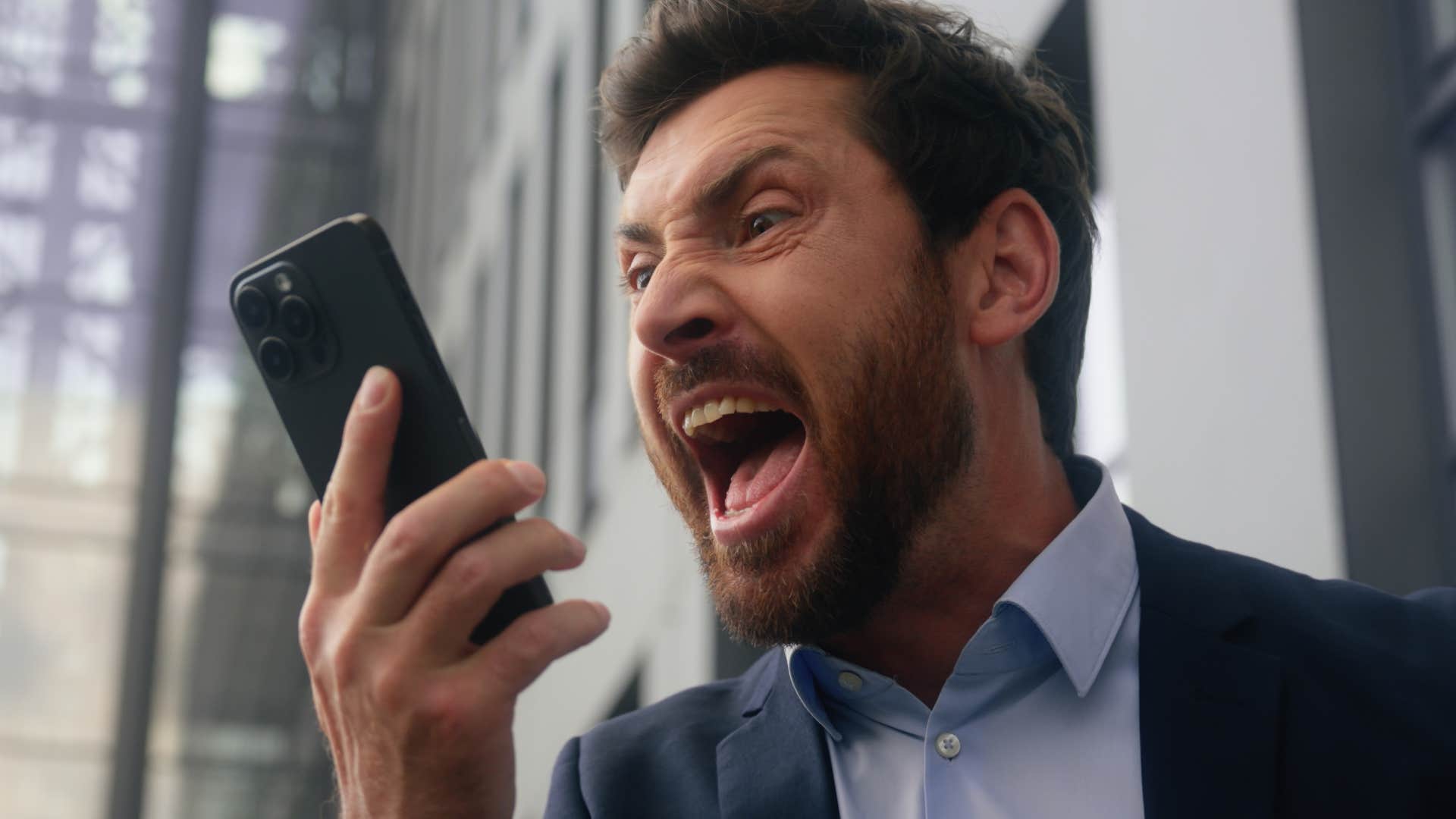 angry man overreacting to small triggers arguing on his phone